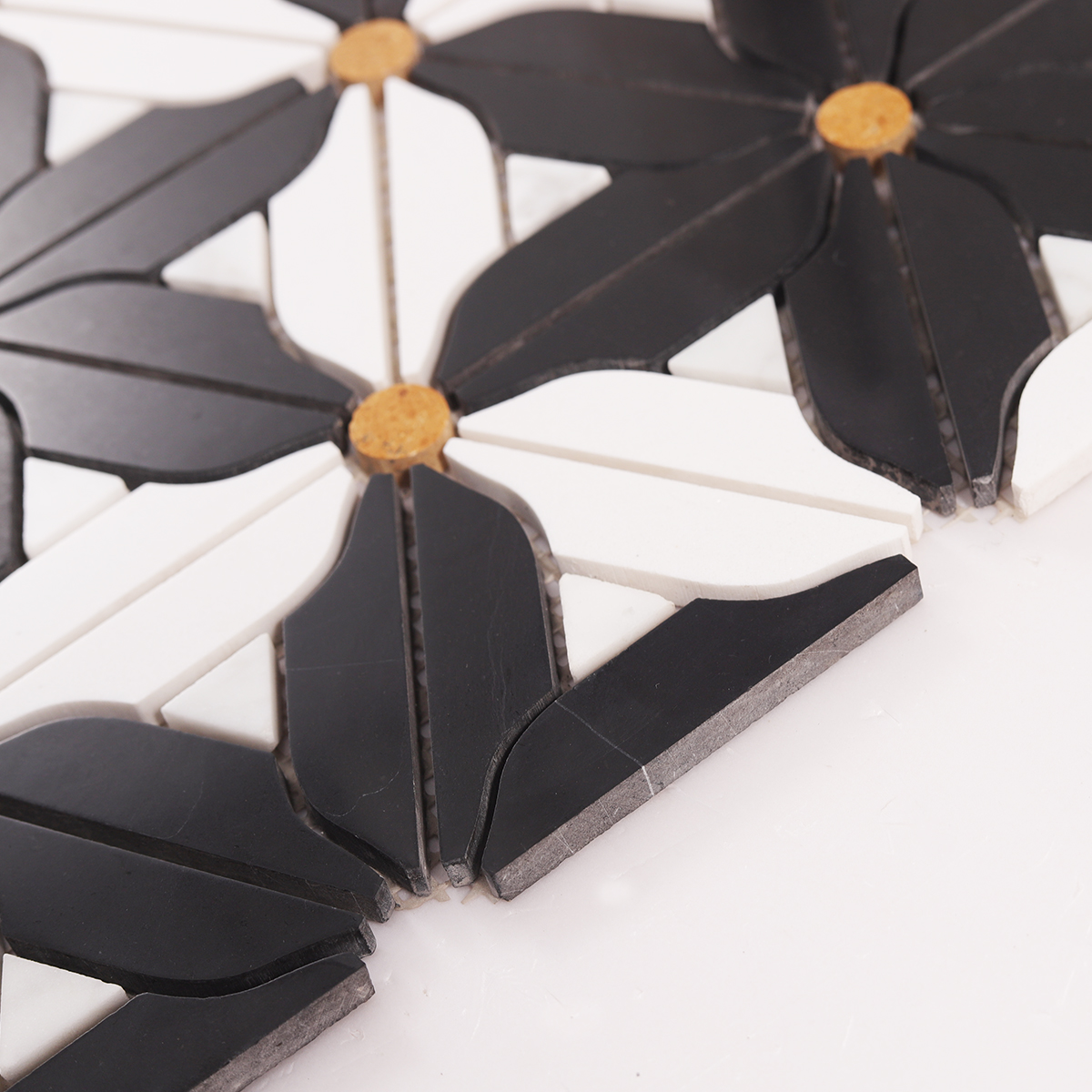 Side close-up view of black and white flower marble mosaic tiles, showing texture and thickness.