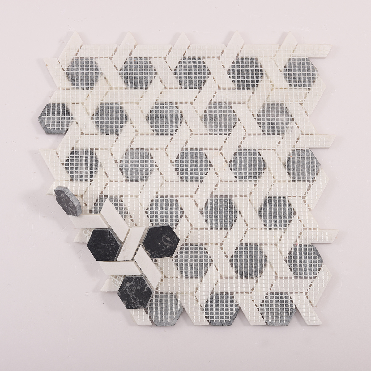 Folded back side of gray and white hexagonal lattice marble mosaic tiles