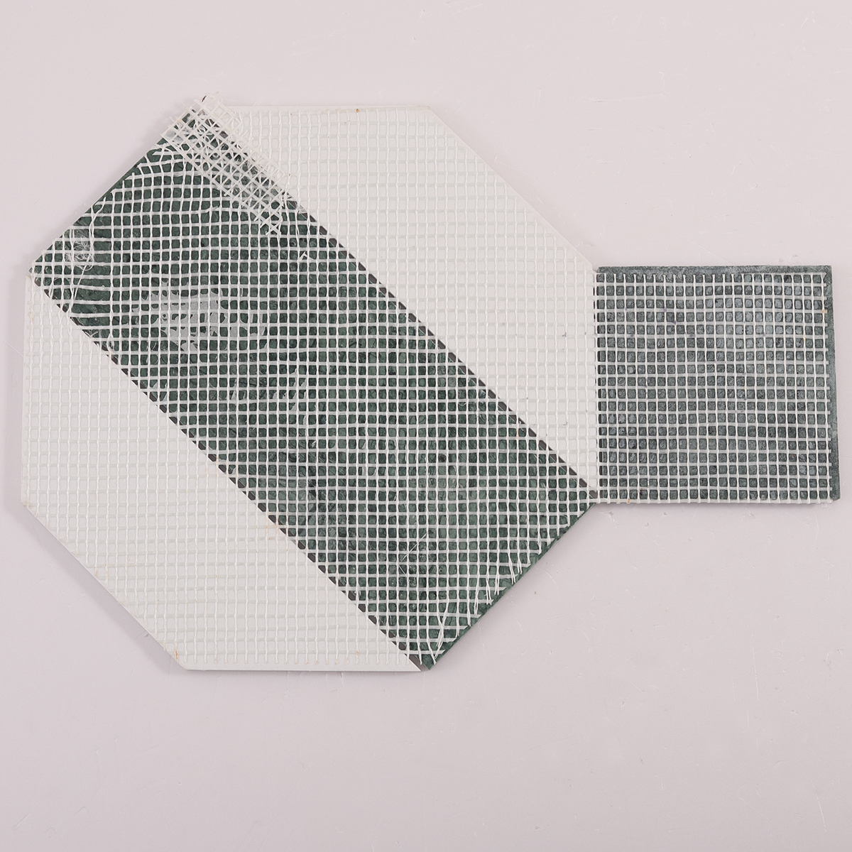 Back side of big hexagon green and white marble tiles