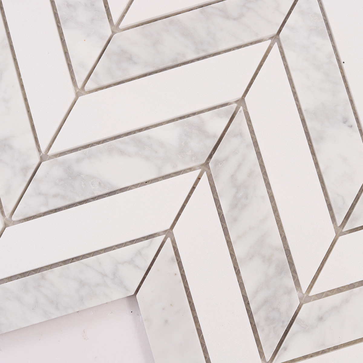 Close-up of Herringbone Carrara White marble mosaic tiles