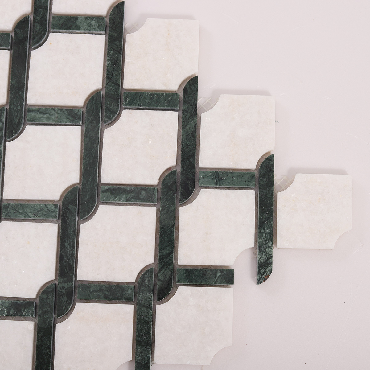 Detailed close-up of Thassos Green and White Princess Weave natural stone mosaic tiles