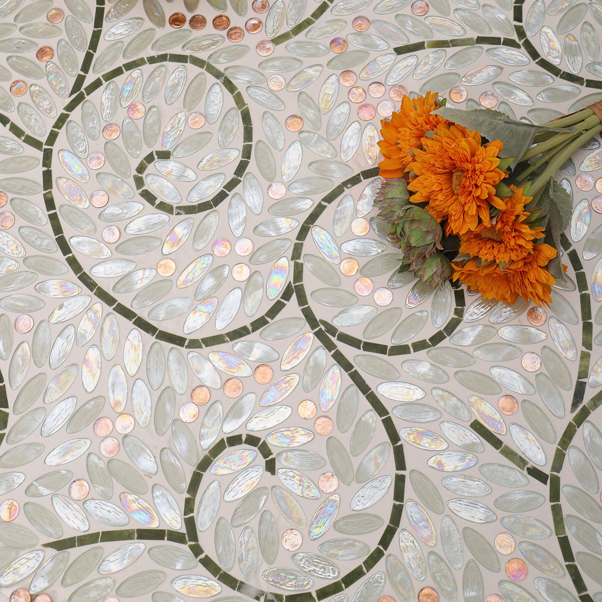 White Oval Glass Mosaic Art Tiles on the floor with a floral arrangement