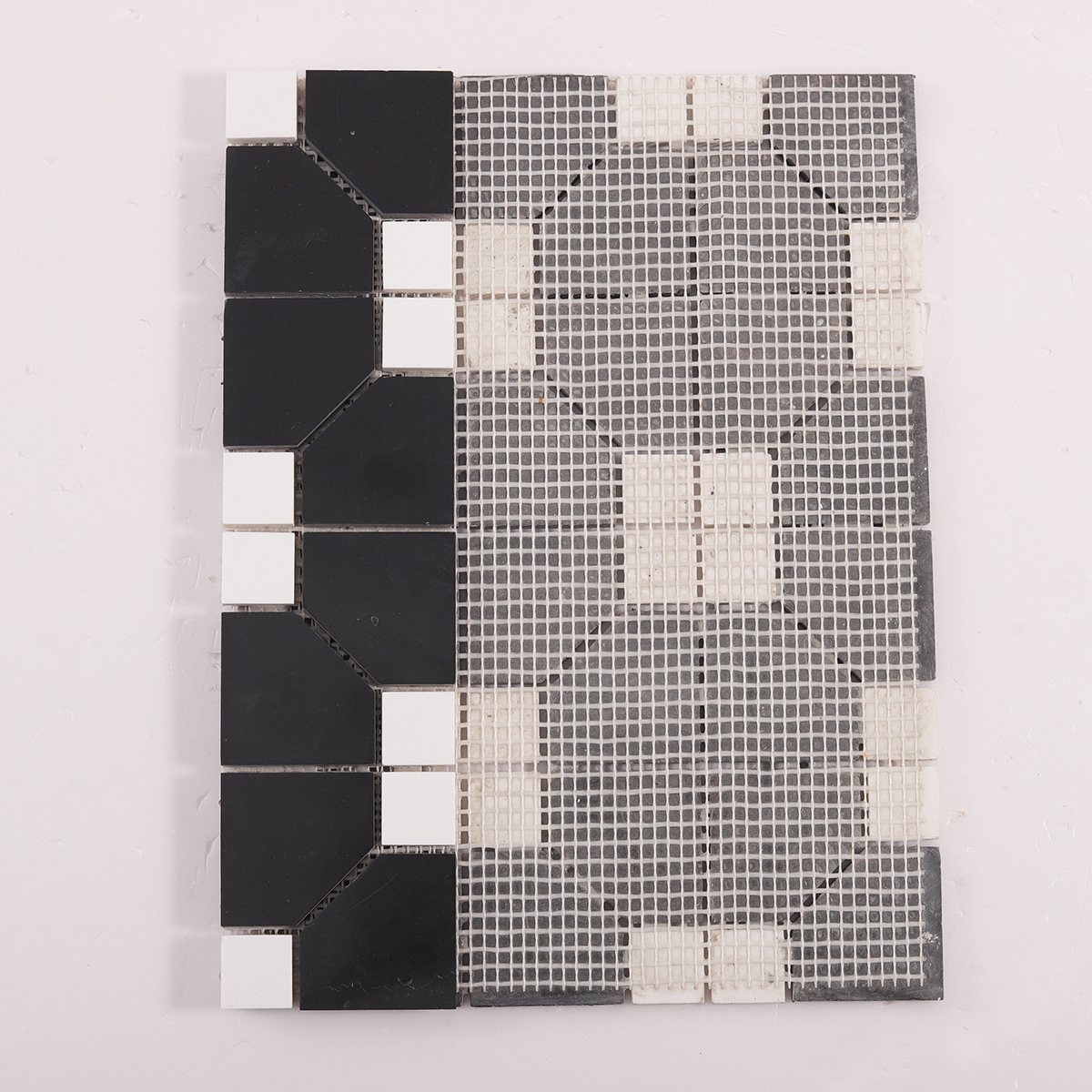 Folded back side of Black and White Hexagon Geometric Marble Mosaic Tiles.