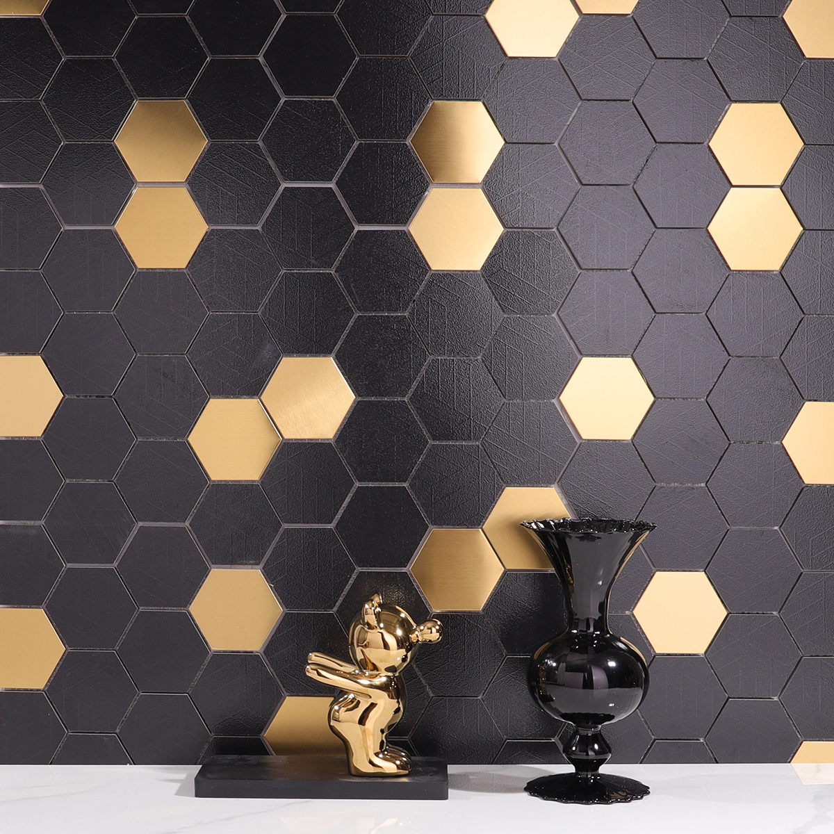  Black and Gold Hexagon Mosaic Tiles on the wall, white floor tiles, complemented by a black vase
