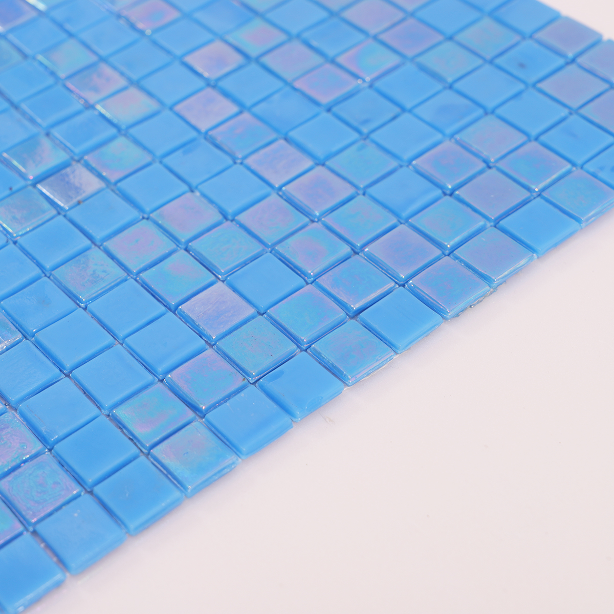 Side view close-up of Iridescent Blue Glass Square Mosaic Floor Tile, clean edges visible