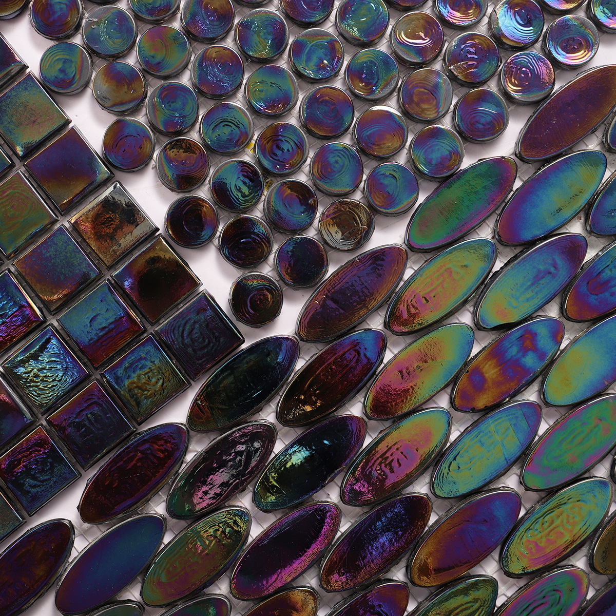 Close-up of Oval Iridescent Black Glass Mosaic Floor Tile, smooth and reflective surface