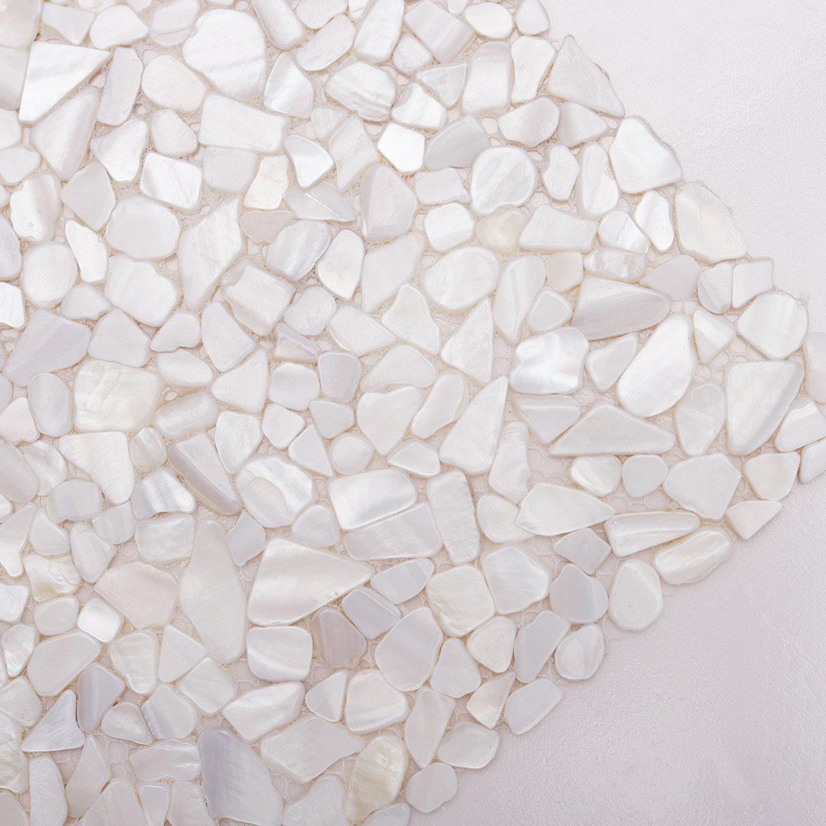  Close-up of White Mother of Pearl Pebbles Mosaic Tiles, highlighting polished texture 