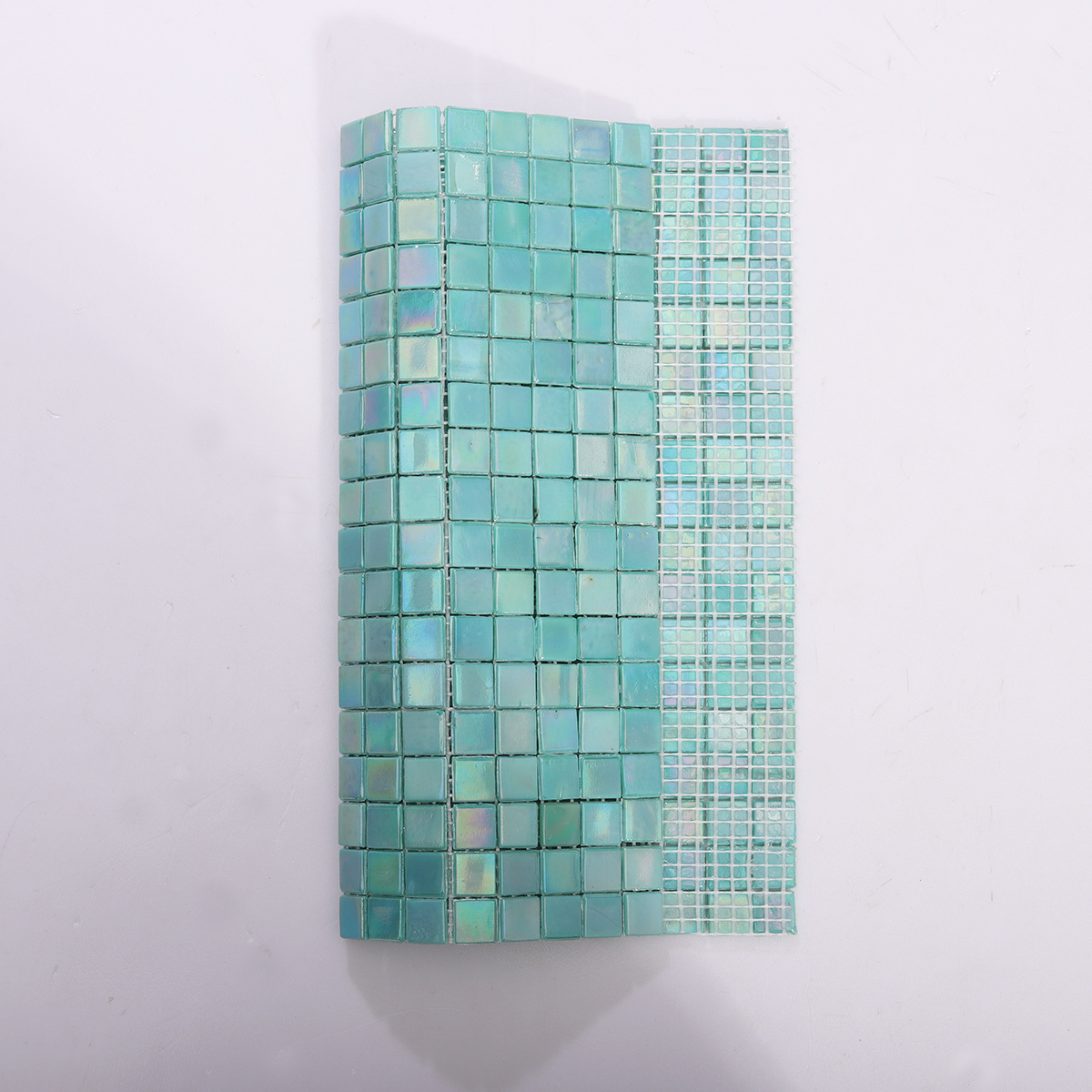 Backside of Iridescent Blue Green Mosaic Pool Tile with Mesh Backing