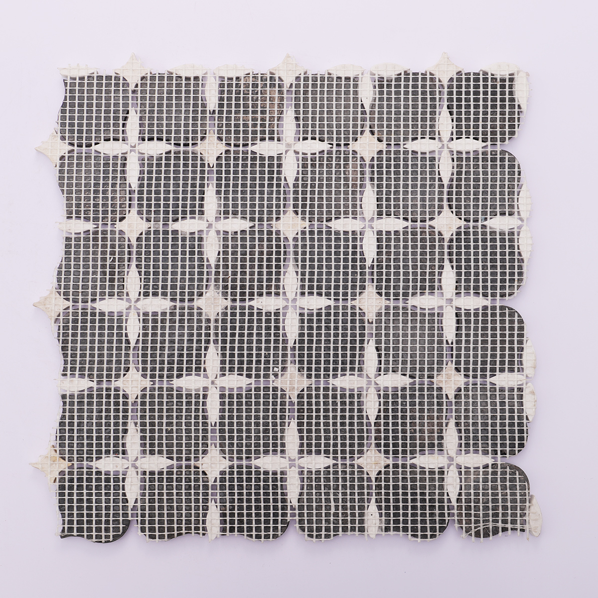 Black and white stone mosaic tiles with mesh backing for easy installation and secure fit.