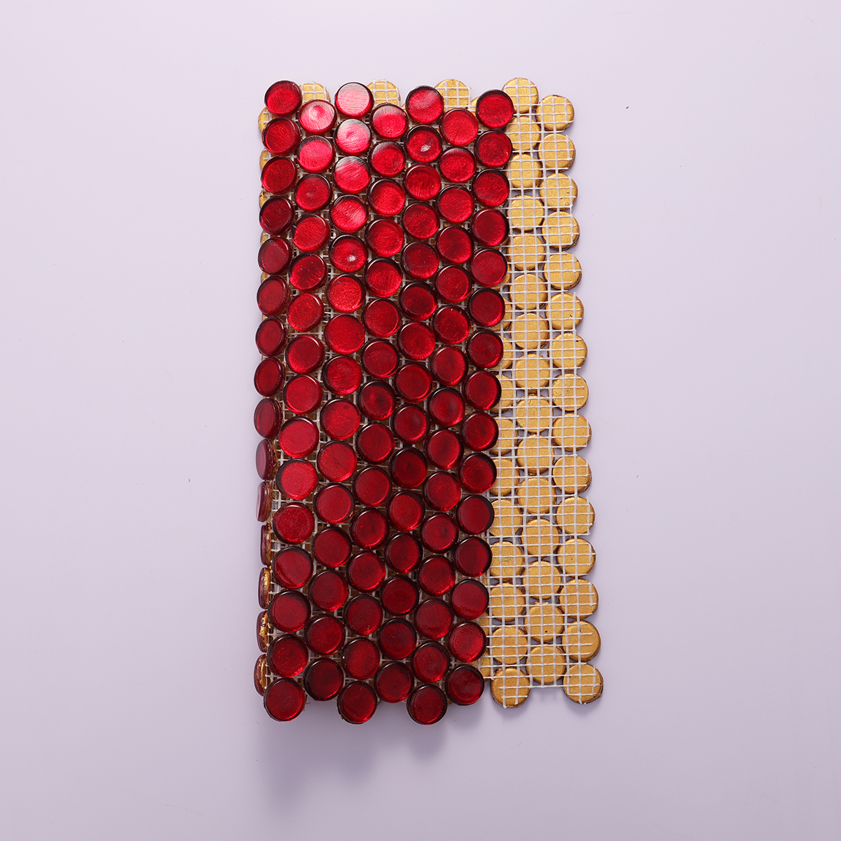 Back view of red glass circular mosaic tiles with mesh backing