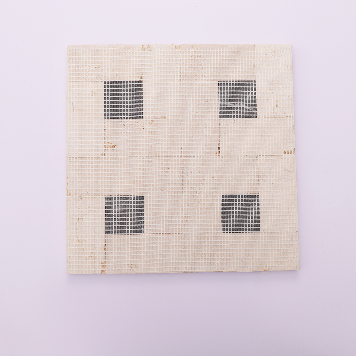 Back view with mesh backing of beige with black polished marble square mosaic tiles.