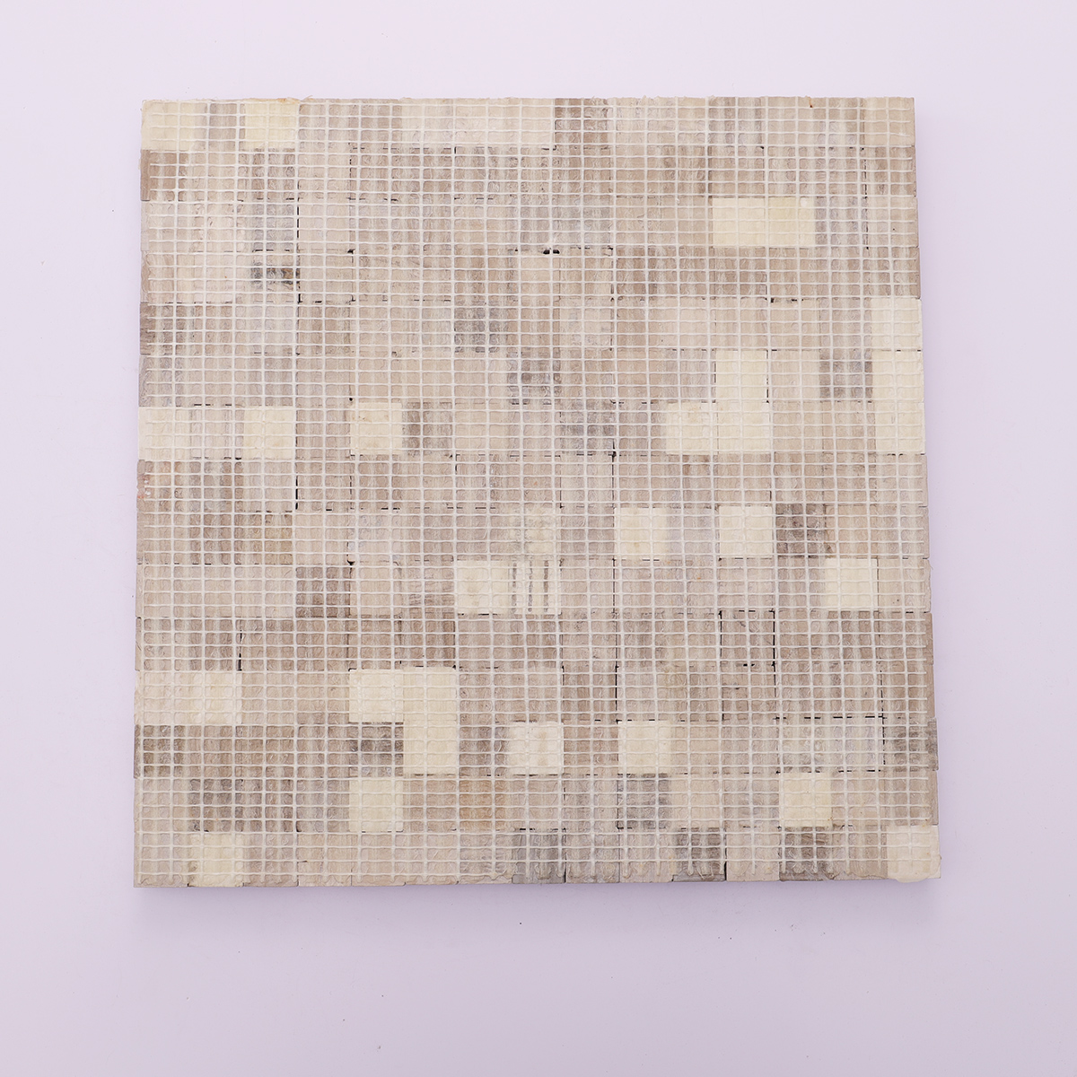 Back view with mesh backing of 3D gray bread curved square marble mosaic tiles.