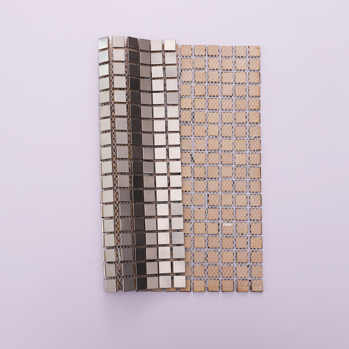 Back view of brushed silver stainless steel tiles with mesh backing