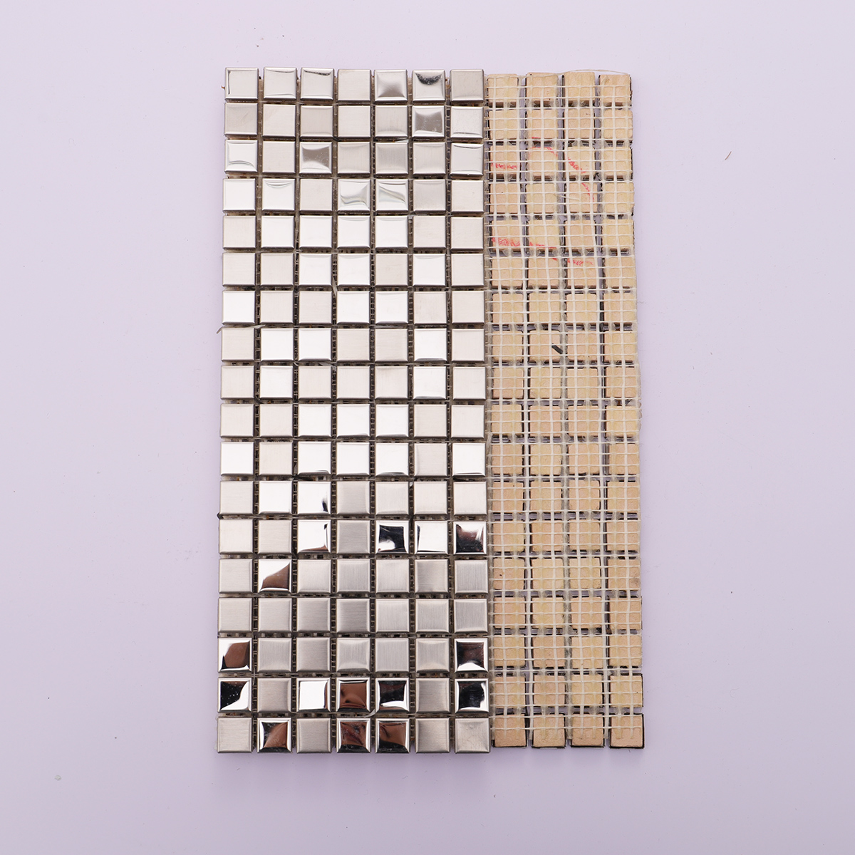 Back view of stainless steel silver mosaic tiles with mesh backing for easy installation.