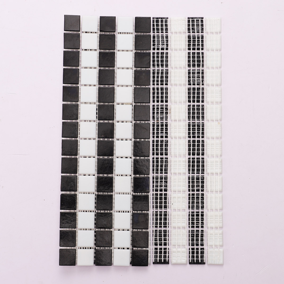 Back side of black and white stripe vintage glass mosaic tiles, folded.