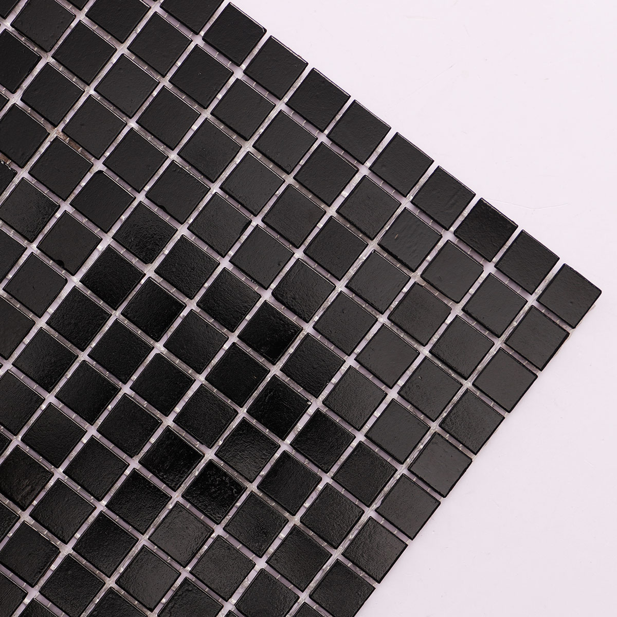 Close-up view of black square fired earth glass mosaic tiles 15mm x 15mm.
