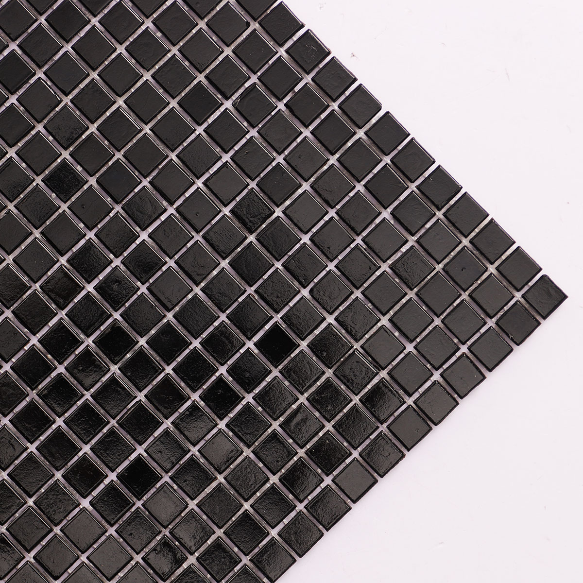 Macro close-up of black square glass tiny mosaic tiles 10mm x 10mm.