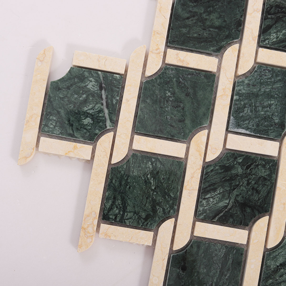Close-up view of Rockart Medallion Green polished marble mosaic tiles.