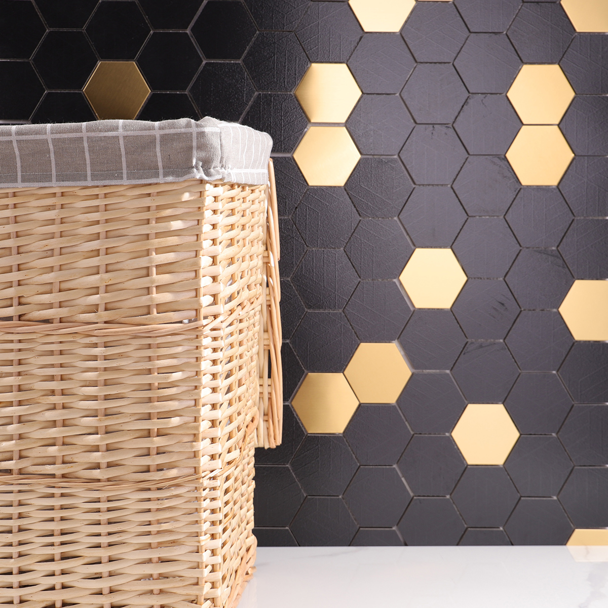Bathroom featuring Black and Gold Hexagon Mosaic Tiles, white floor tiles, and modern fixtures