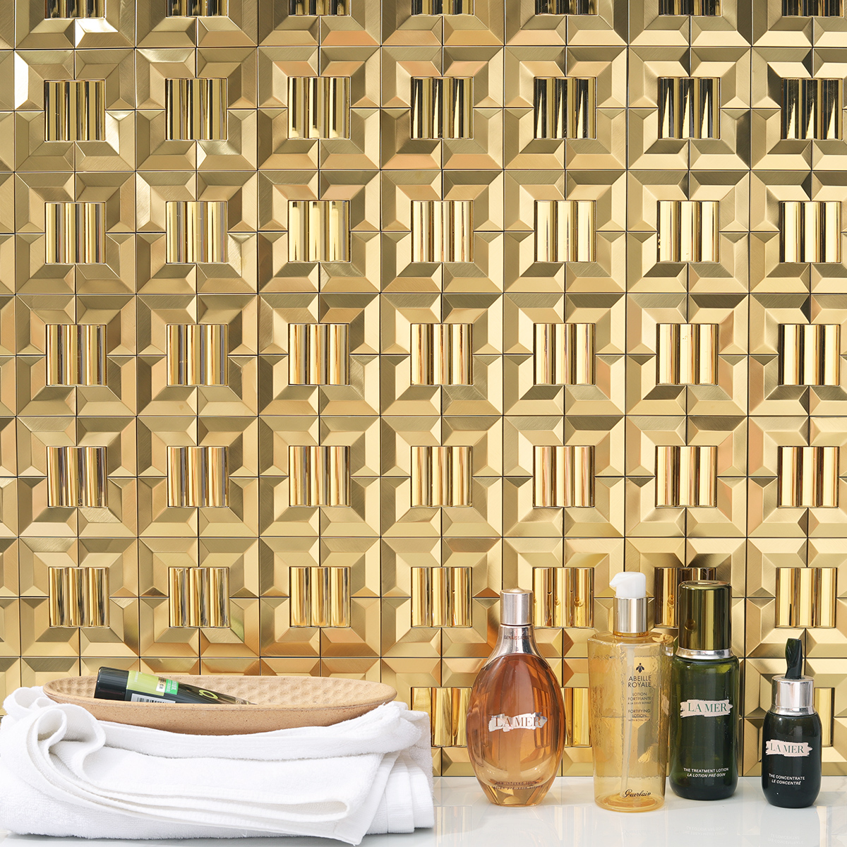 Gold 3D mosaic backsplash on the wall, white floor tiles, with skincare products 