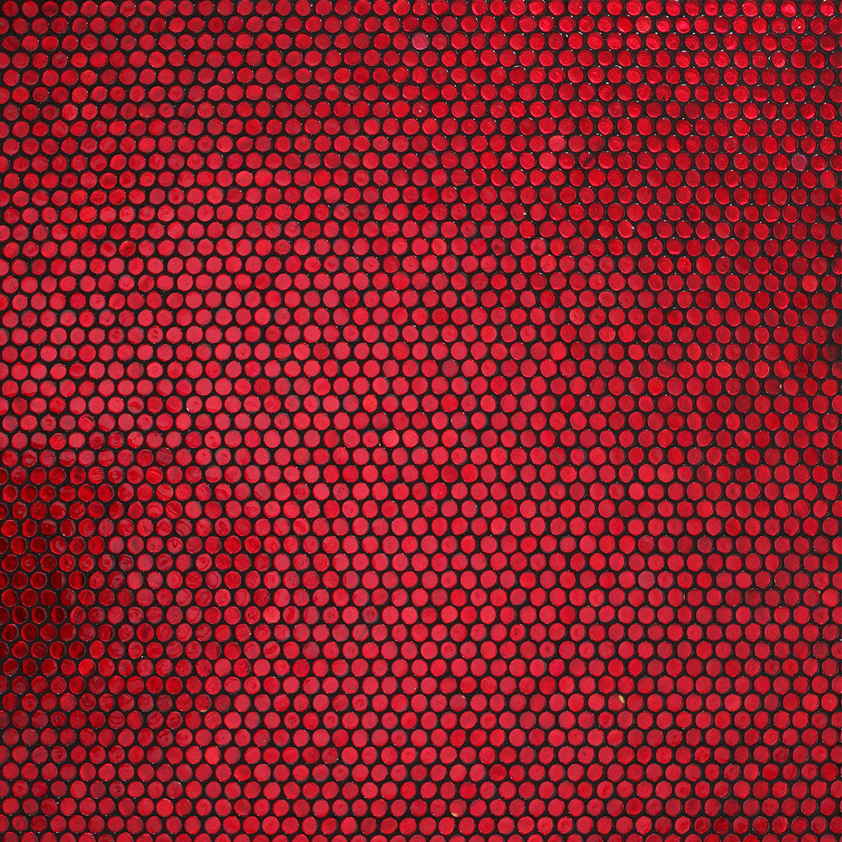 Detail of red glass circular mosaic tiles after grouting