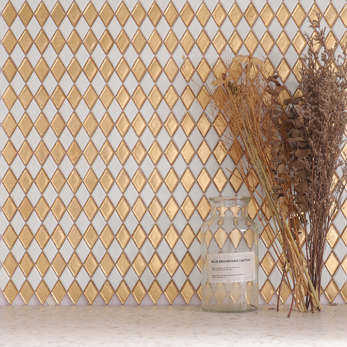 Wall adorned with gold and white diamond-shaped mosaic tiles in a checkerboard pattern.