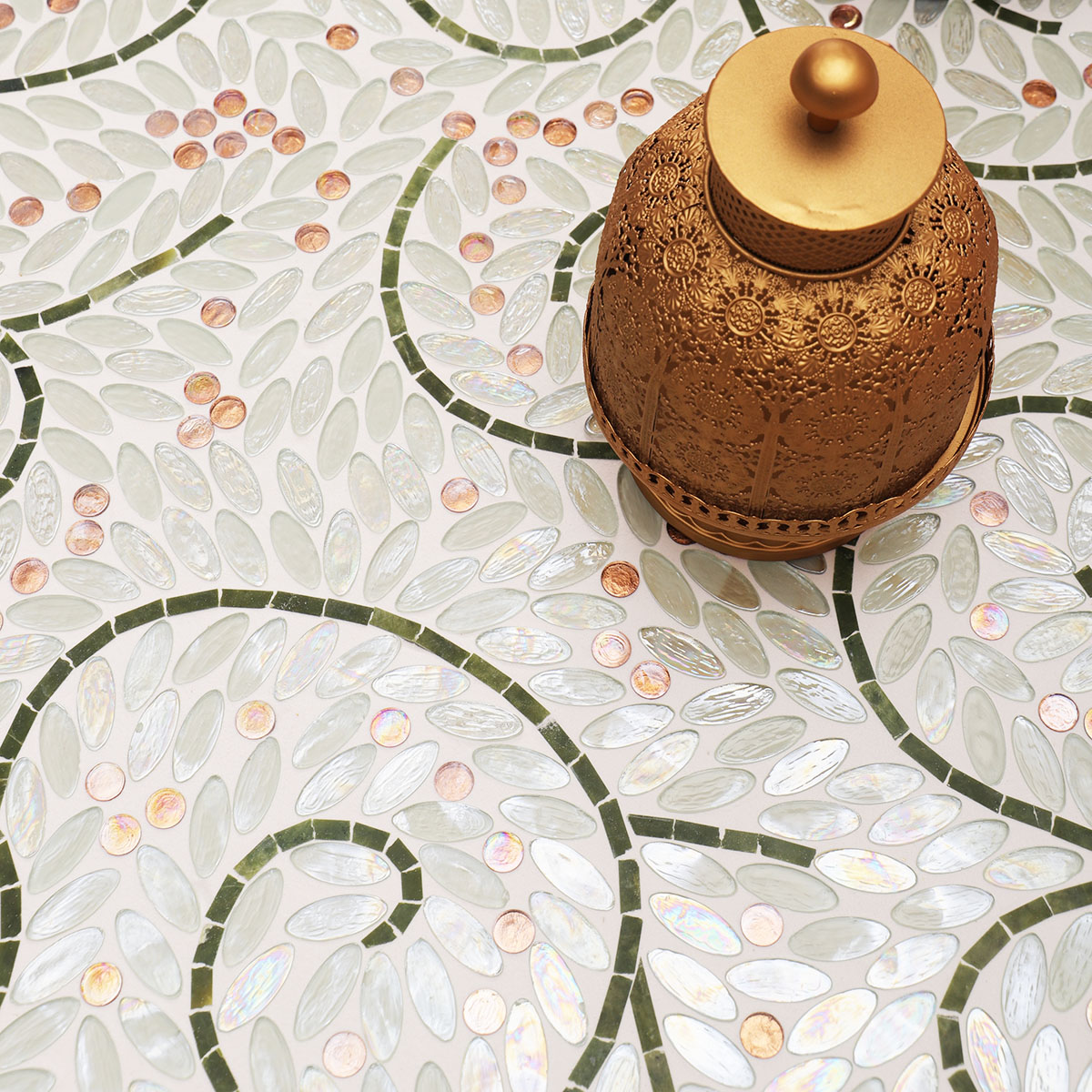 White Oval Glass Mosaic Art Tiles with copper decorative items on the floor