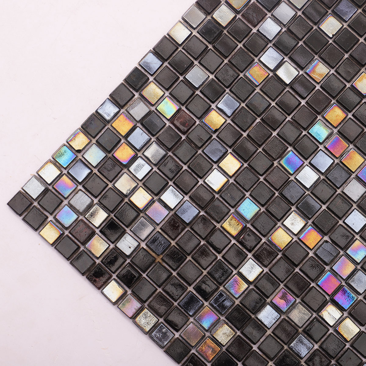Close-up of Mini Black Square Iridescent Glass Mosaic Tiles, vibrant texture