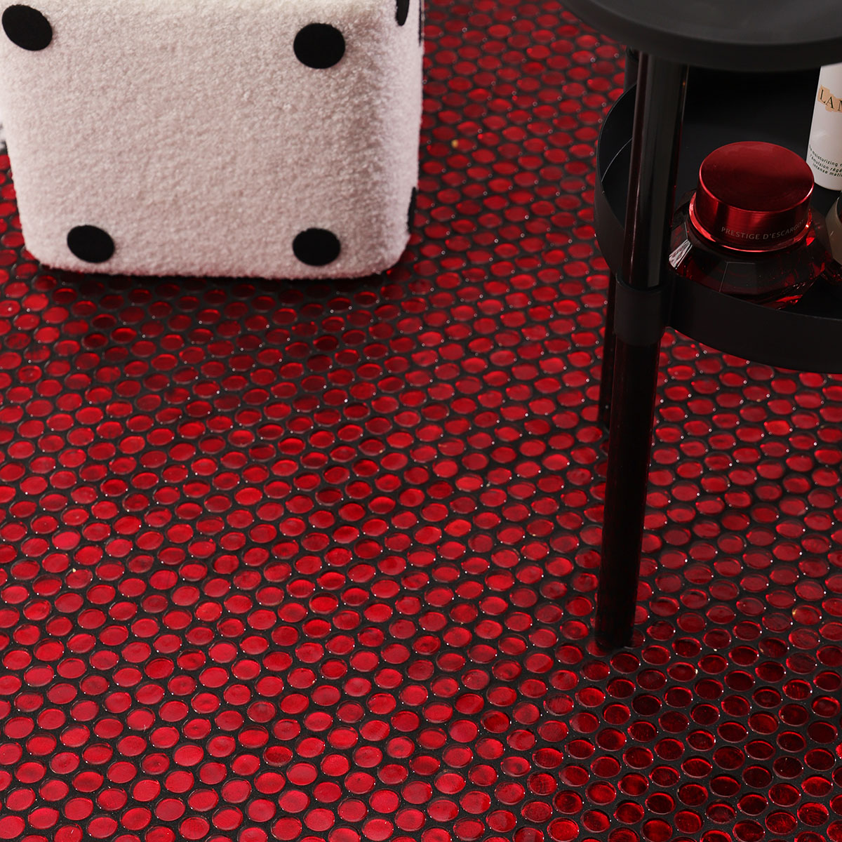 Floor view of red glass circular mosaic tiles with black grout.
