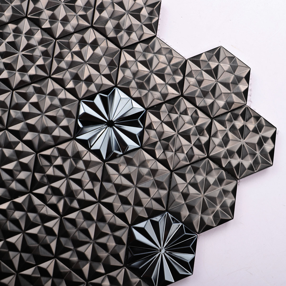 Close-up of black metal 3D groutless hexagon mosaic tile in stainless steel.