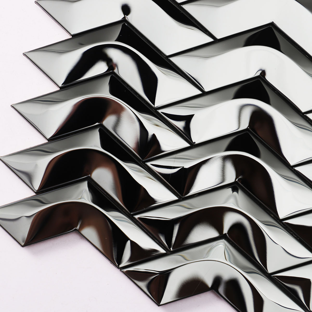 Texture close-up of black stainless steel chevron 3D mirror mosaic tiles.