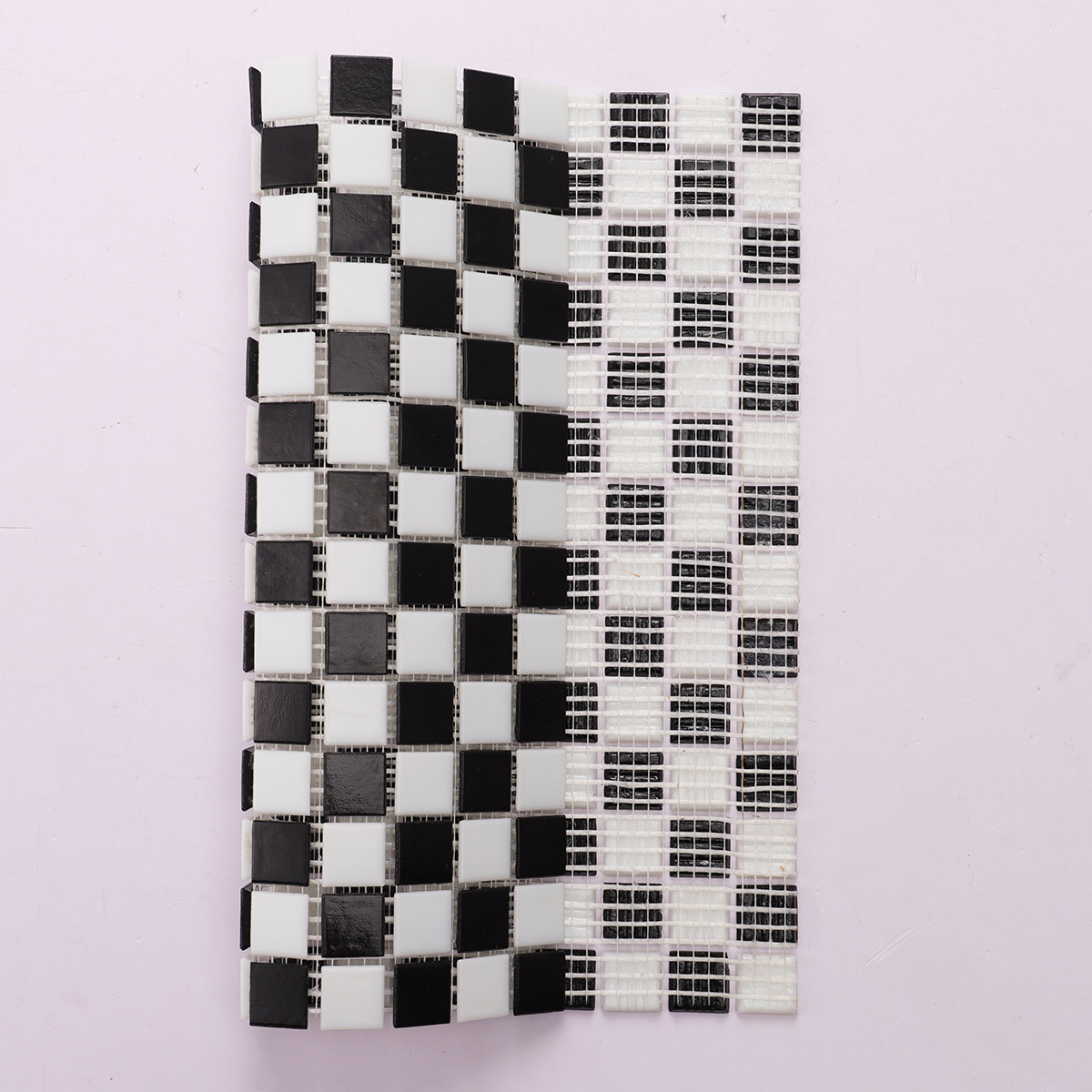 Folded back side of black and white vintage checkerboard mosaic tiles.