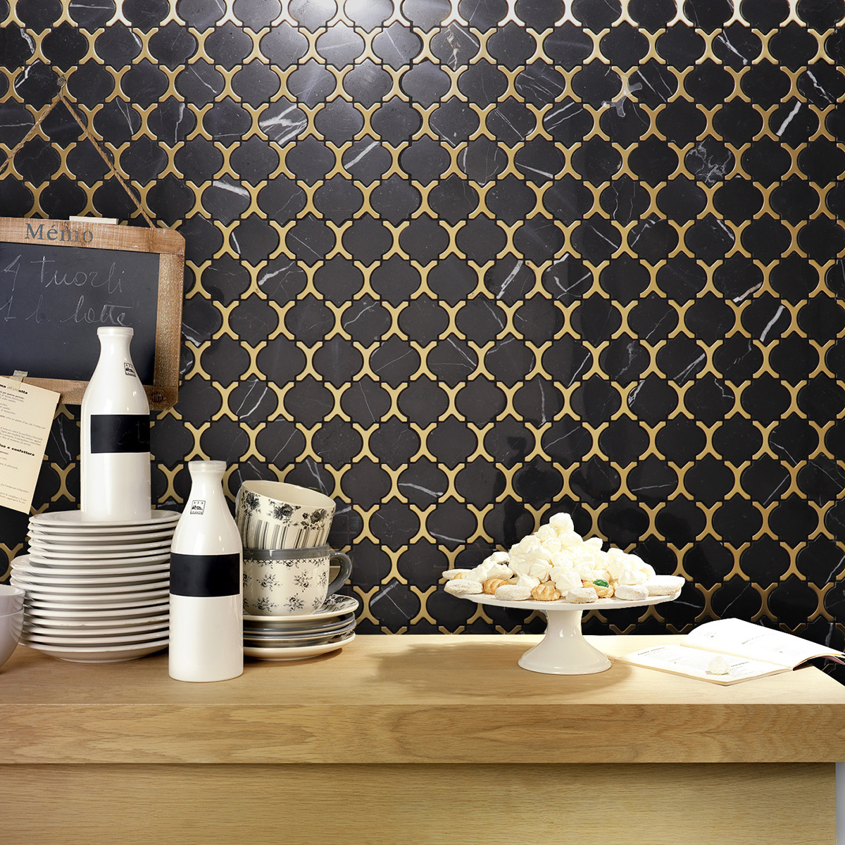 Black marble and gold stainless steel arabesque mosaic tiles on kitchen wall.