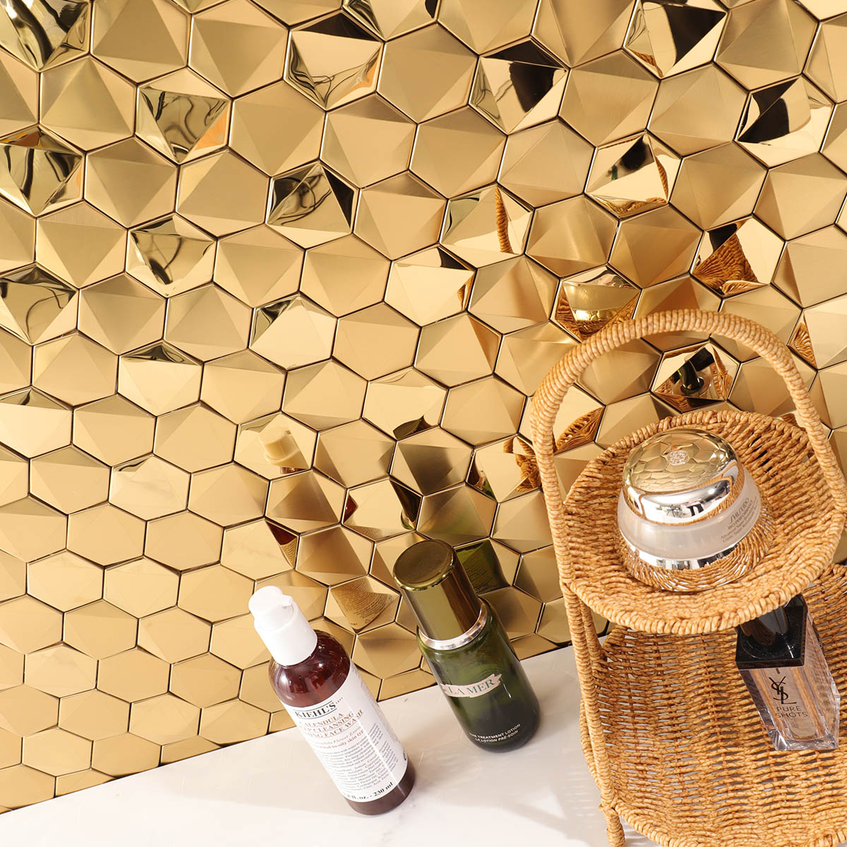 Hexagon gold 3D stainless steel mosaic tiles on a stylish bathroom wall with white floor tiles.