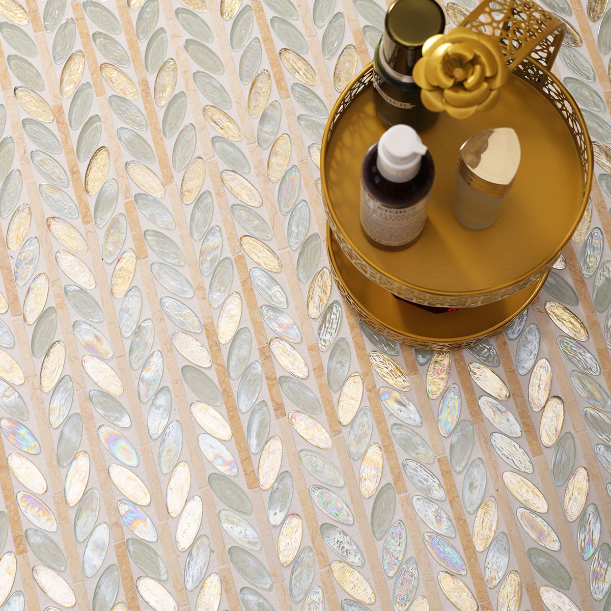 Elegant floor scene featuring Glass and Marble Oval Leaf Mosaic Tiles and skincare products.