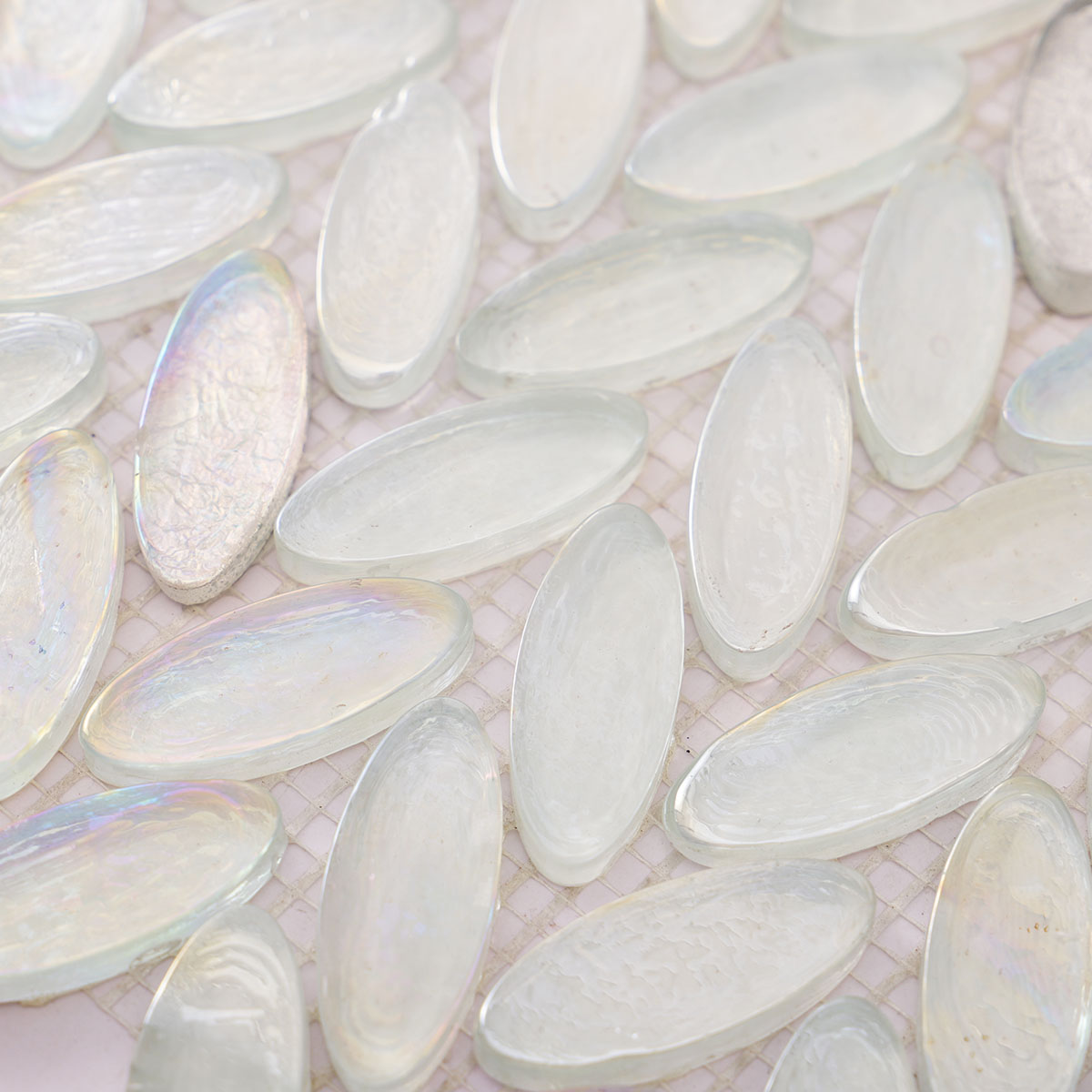 Detailed close-up of Iridescent White Oval Glass Mosaic Tiles.