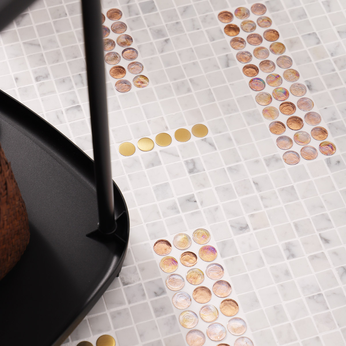 White marble mixed metal and glass mosaic floor tiles with a stool