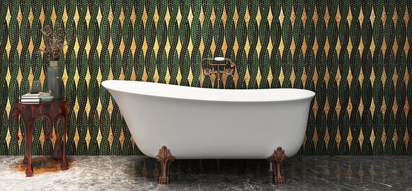 Chic bathroom with green and gold mosaic tiles behind a vintage bathtub.
