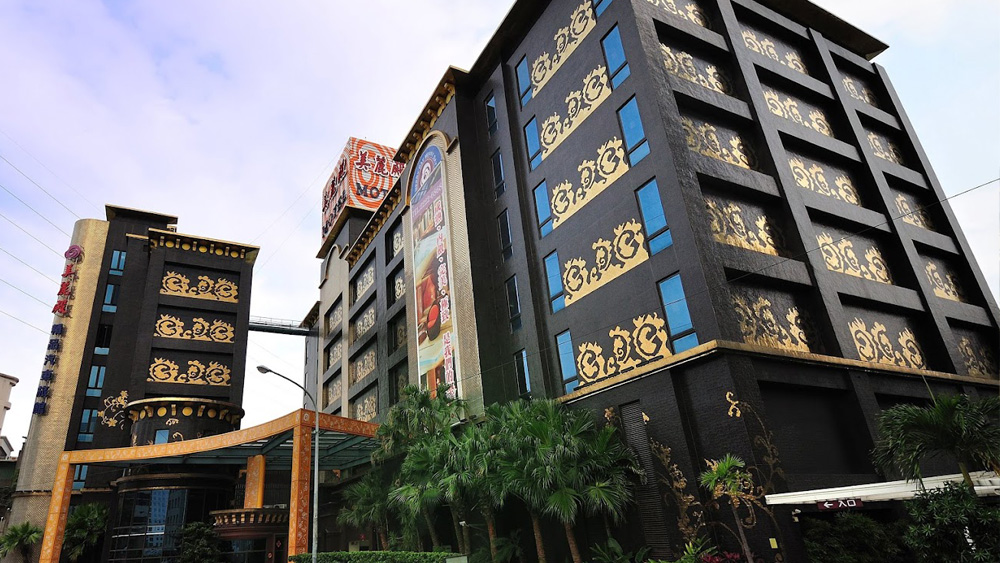 Side view of the hotel, revealing intricate mosaic patterns on the exterior wall.
