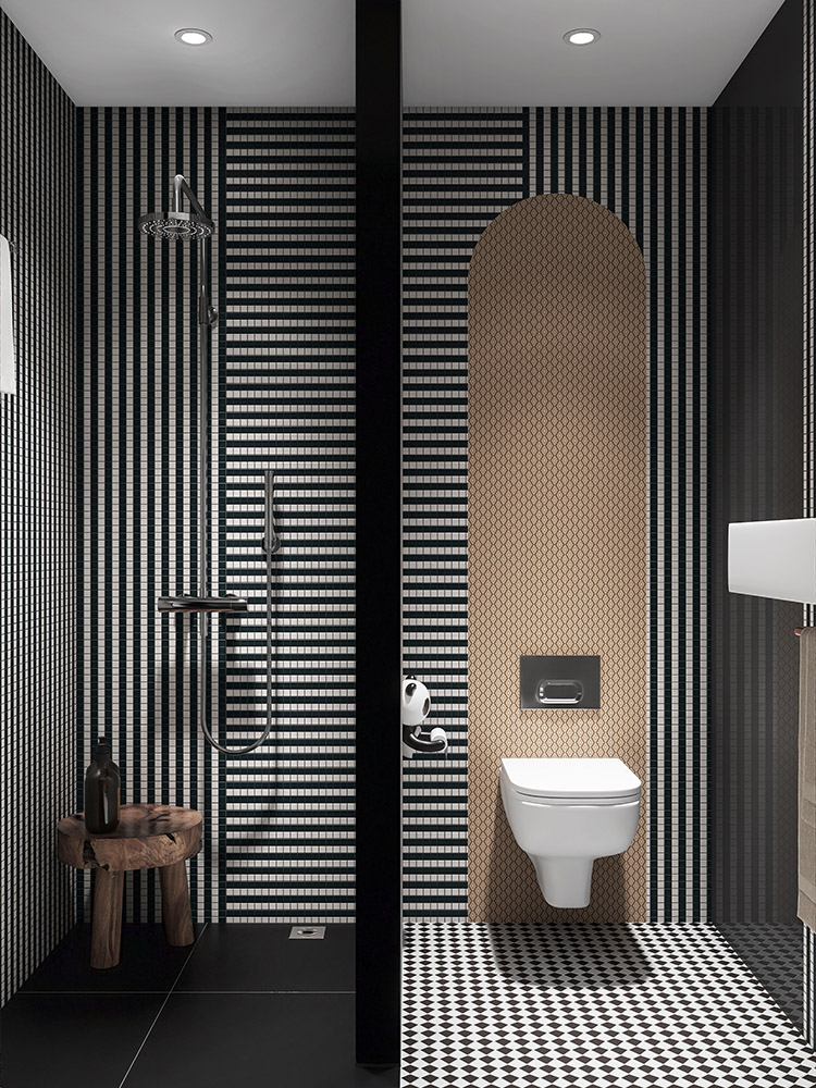 Black and white striped mosaic tiles in the bathroom with a partition between the shower and toilet.