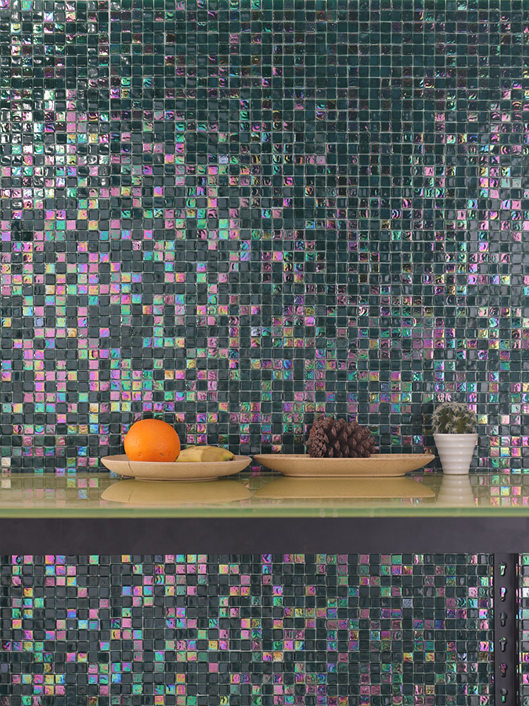 Dark green mosaic tiles on the wall with fruit baskets on the table.
