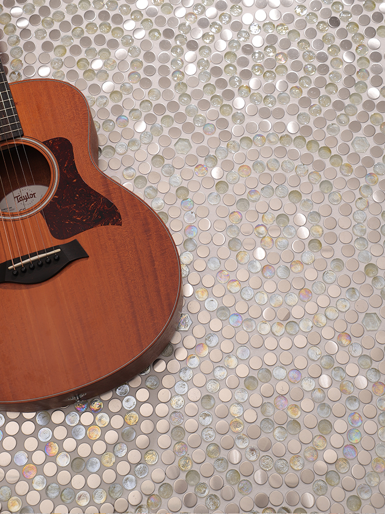 The elegant white and silver round mosaic floor pattern creates a striking visual, with a guitar placed nearby for a musical, artistic ambiance