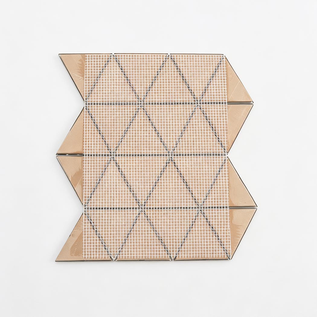 Back view of gold triangle mosaic tile sheet with mesh backing