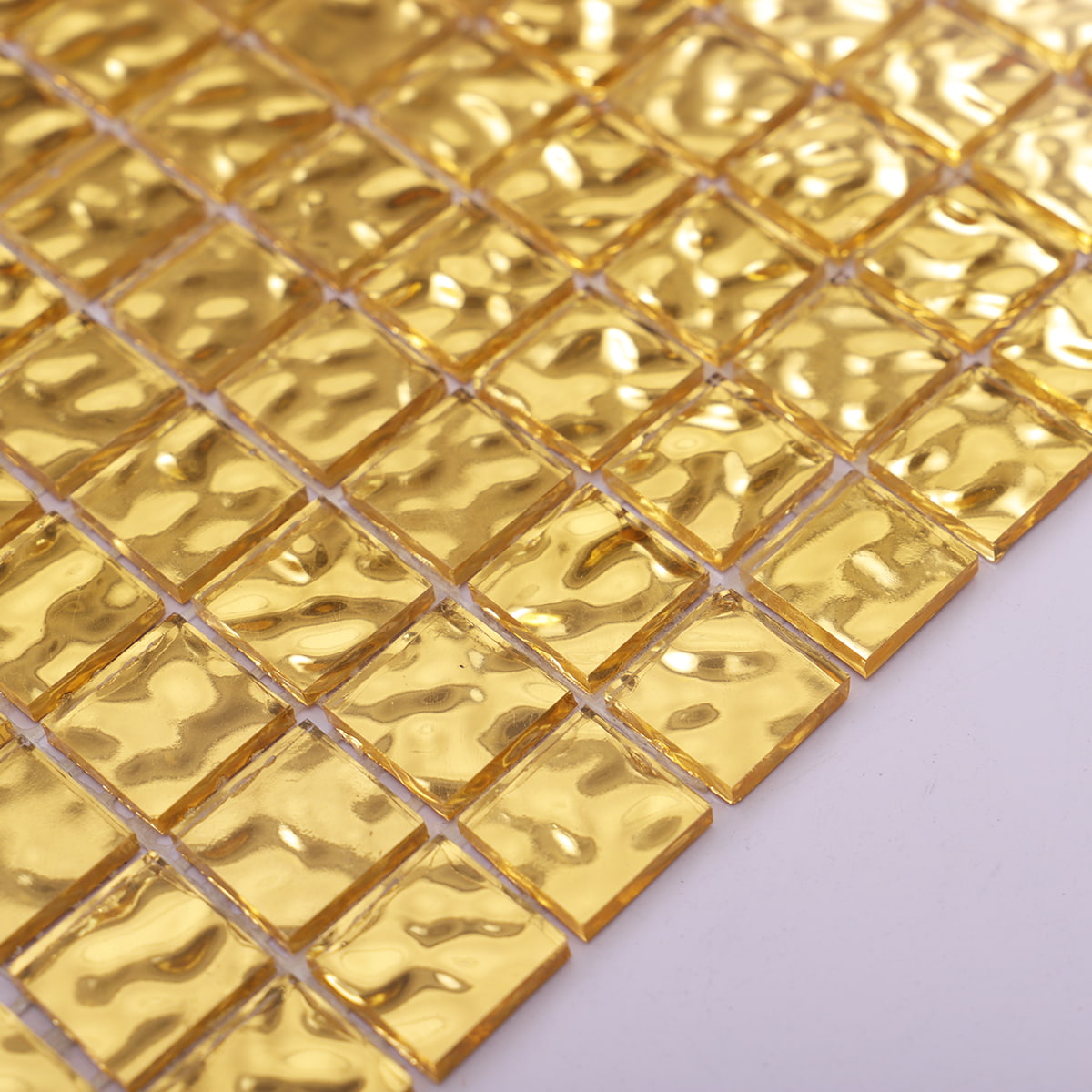 24K gold mosaic tiles with a beautiful wavy texture, perfect for accentuating luxury spaces.