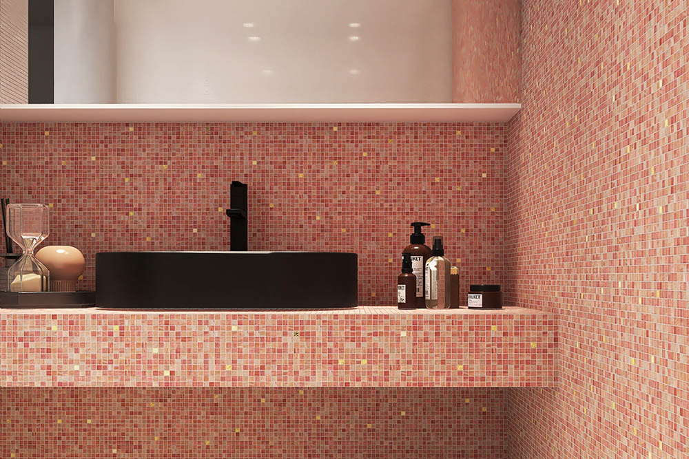 Bathroom walls and countertop covered with pink mosaic tiles.