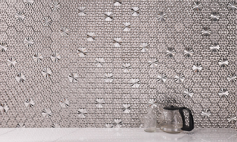 Embossed silver hexagon mosaic tiles on the wall with a vase in front