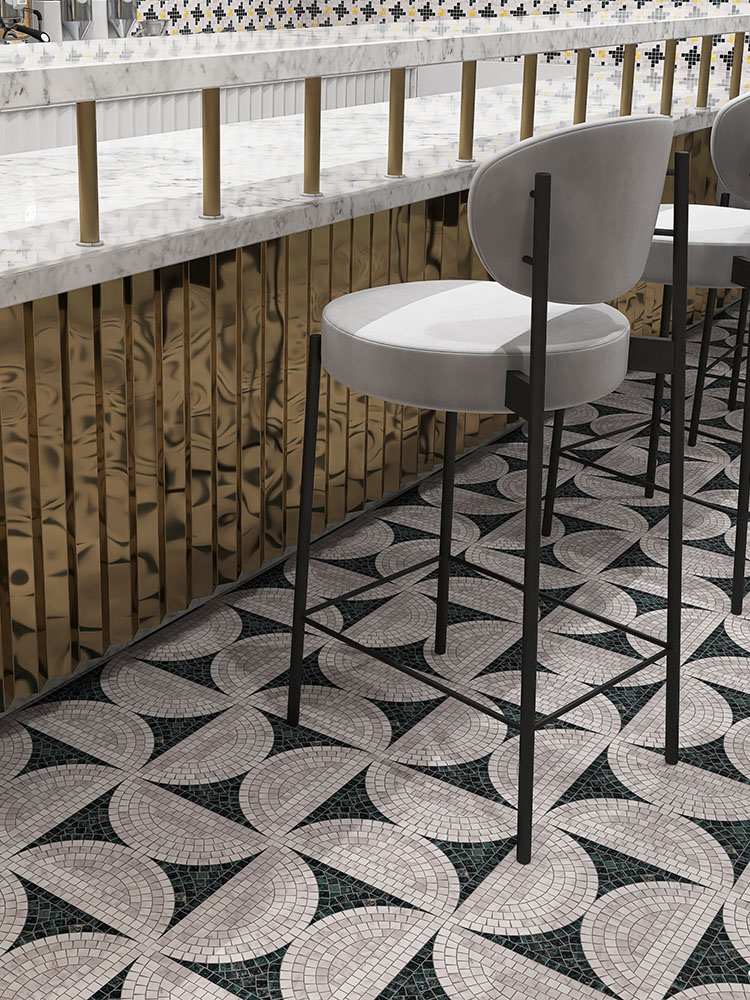 Black and white marble mosaic tiles in a half-circle pattern on the floor.