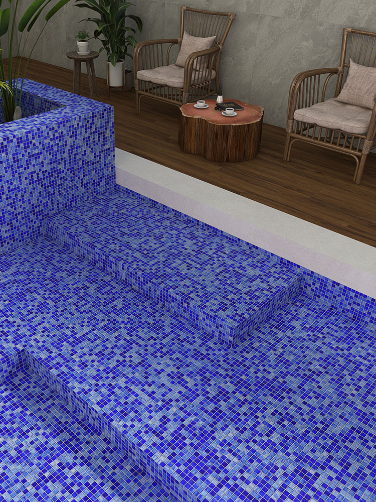 Blue mixed glass mosaic tiles in the pool with stools on the poolside.