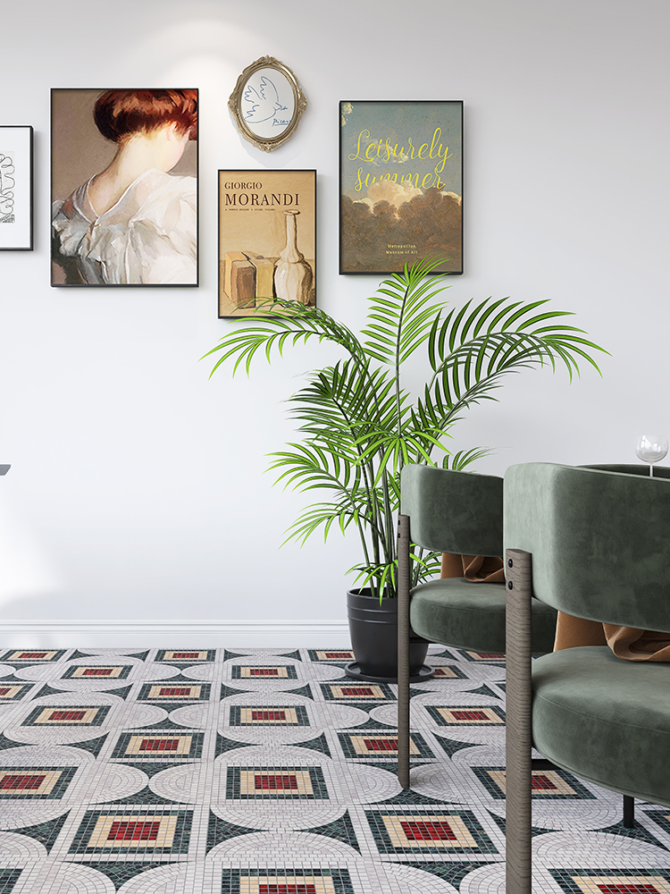 Stone and glass mosaic floor in a living room with a green sofa and plants.