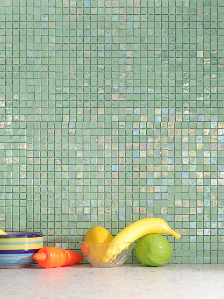 Vibrant green mosaic tiles bring a fresh, lively energy to the kitchen walls, creating a bold and modern look